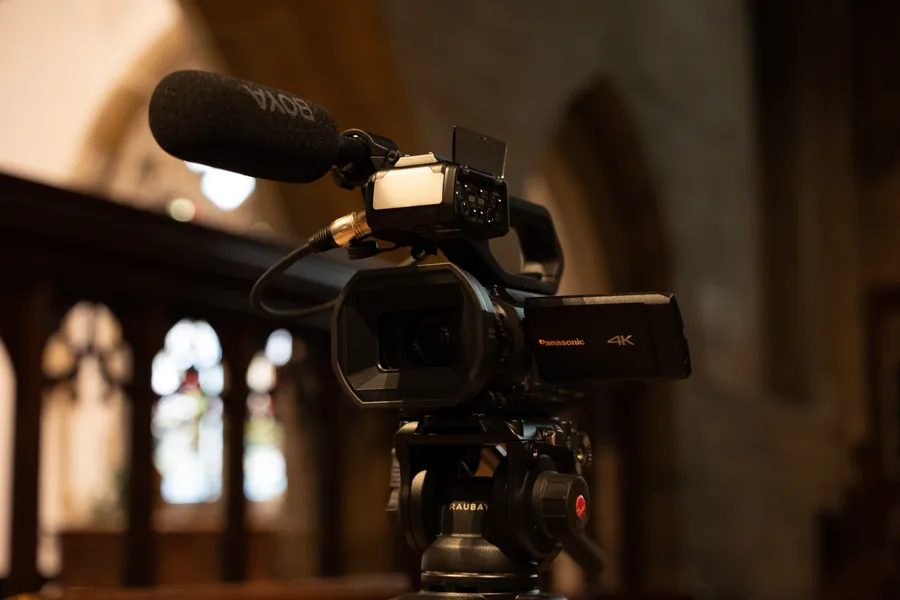 Church interior with stained glass window — funeral live streaming venue